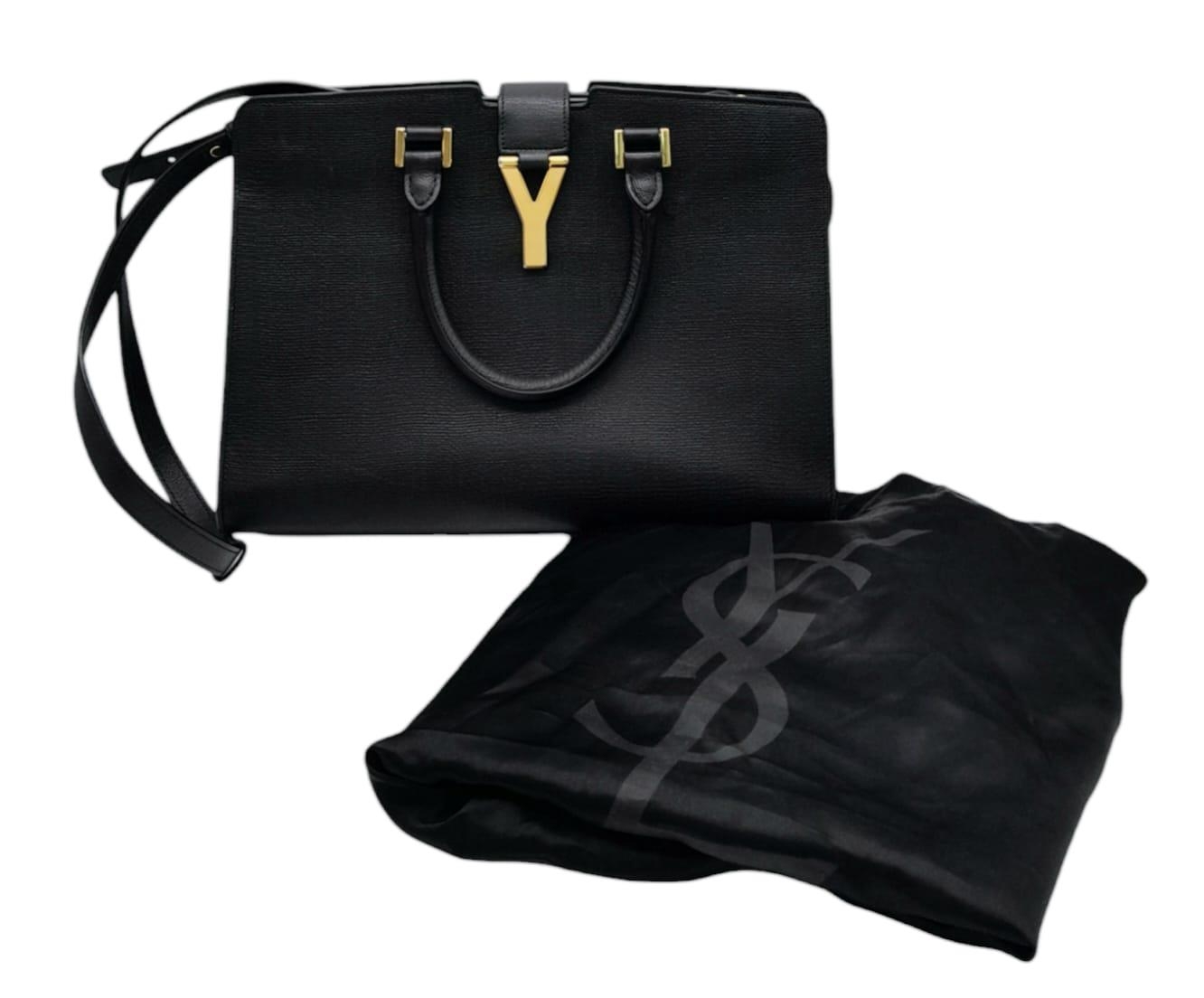 An Yves Saint Laurent Black 'Cabas' Handbag. Leather exterior with gold-toned hardware, two rolled - Image 2 of 8