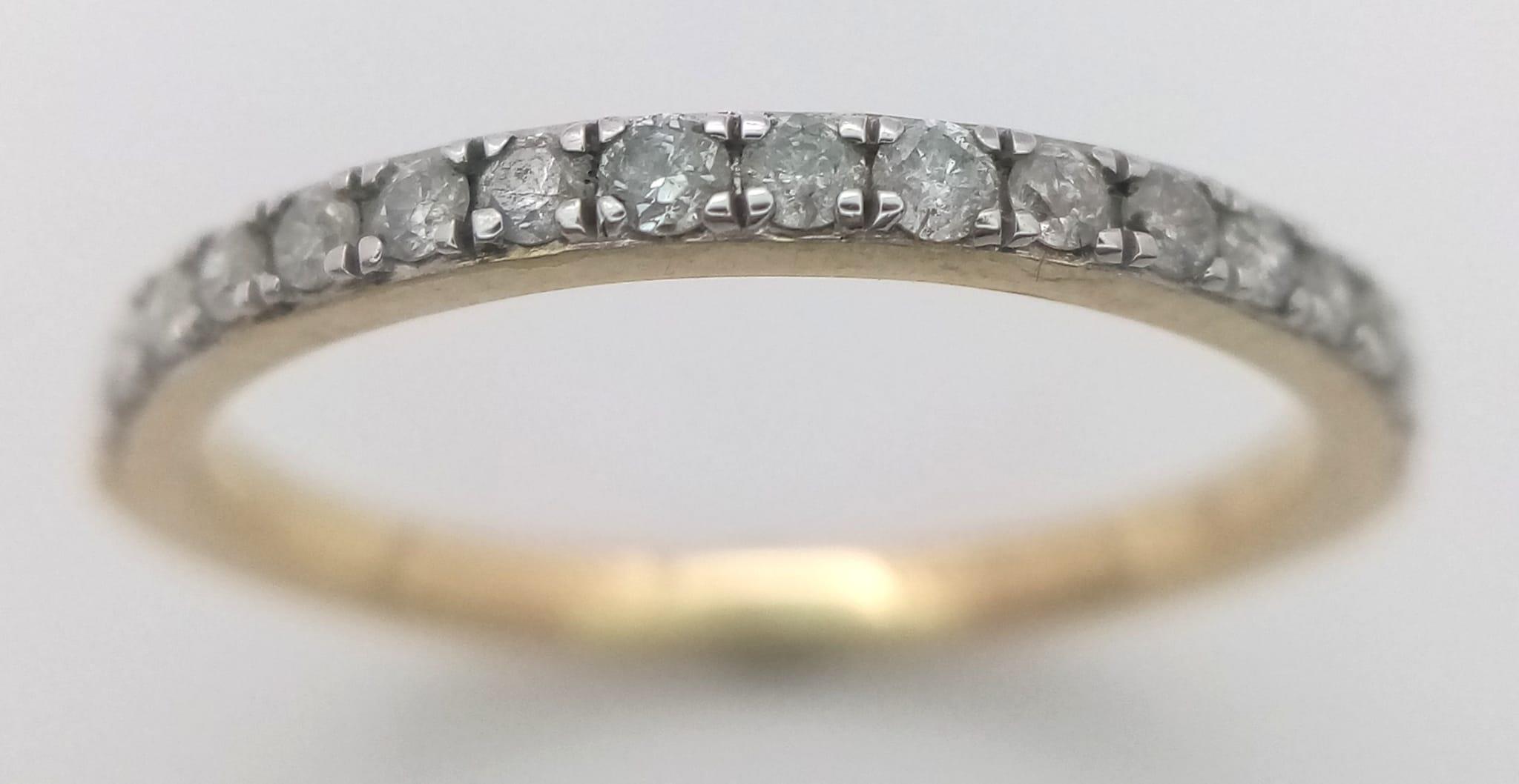 A 9K YELLOW GOLD DIAMOND HALF ETERNITY RING. 0.25CTW. 1.5G. SIZE N.