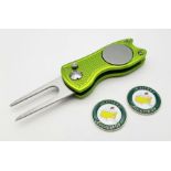 A 'Flick' Tool Golf Putting Green Divot Repairer with two Commemorative 'Masters' Ball Markers. As