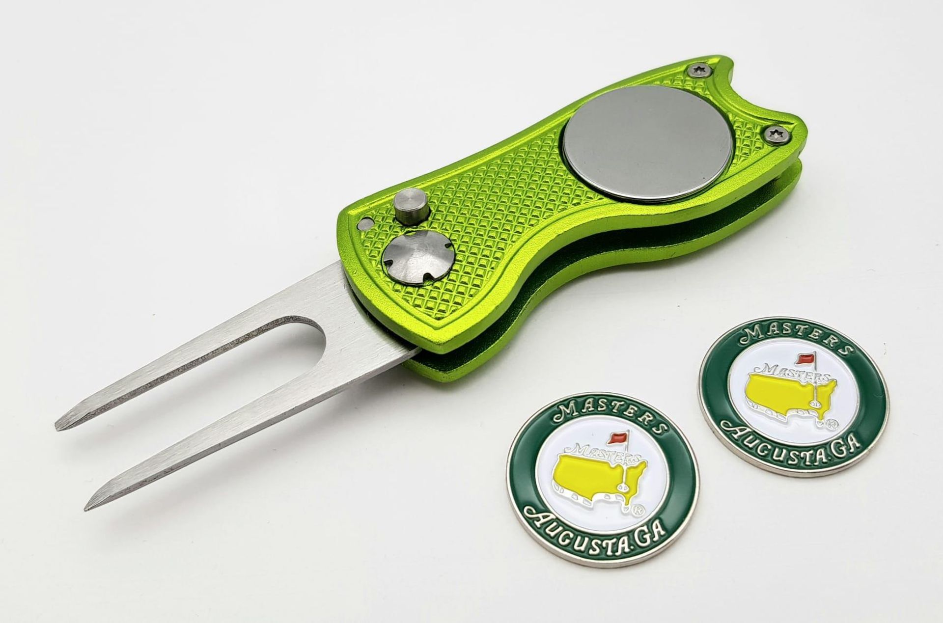 A 'Flick' Tool Golf Putting Green Divot Repairer with two Commemorative 'Masters' Ball Markers. As