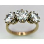 A 9K STONE SET RING WITH A TRILOGY OF SPARKLING ZIRCONIA STONES . 4.2gms size O