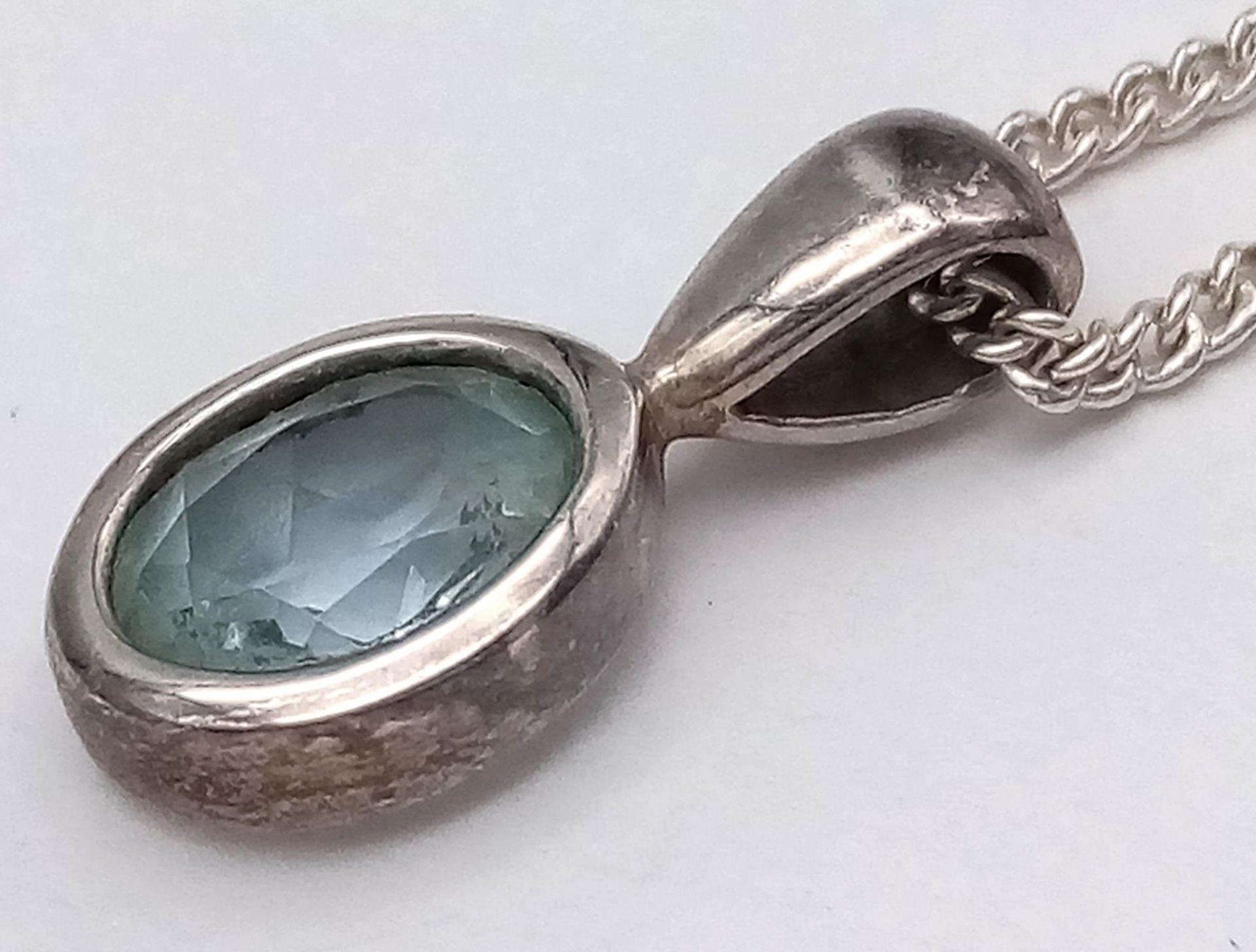 A Sterling Silver Blue Topaz Pendant on Chain. 1.8cm pendant, 46cm chain, 4.7g total weight. Ref: SC - Image 7 of 11