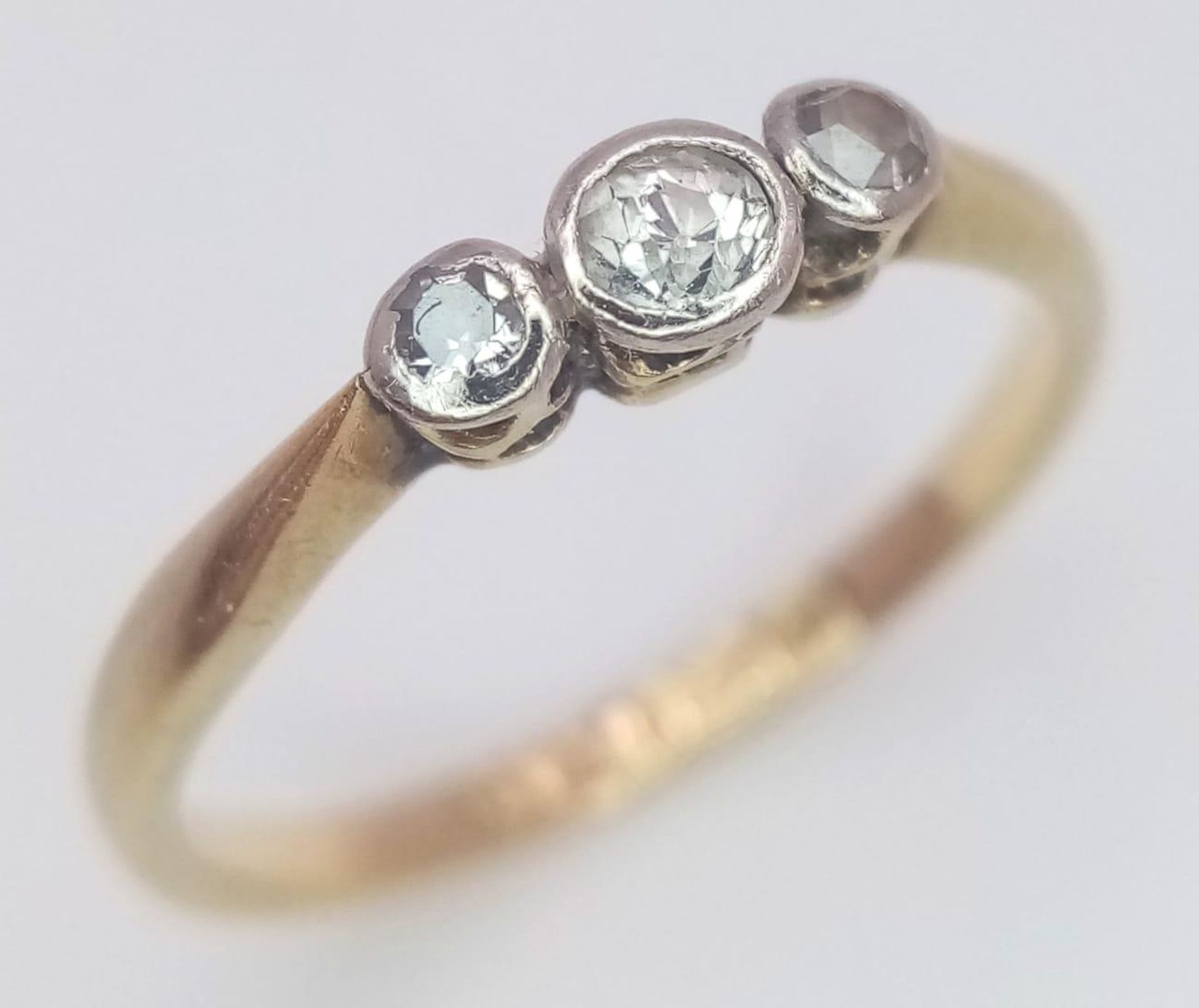 An antique 18 K yellow gold ring with a trilogy of old cut diamonds. Size: M, weight: 1.9 g.