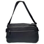 A Prada Black Duffle Bag. Leather exterior with silver-toned hardware, zipped outer compartment to