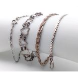 A collection of 4 stylist sterling silver bracelets include a figaro link, twisted, heart link and