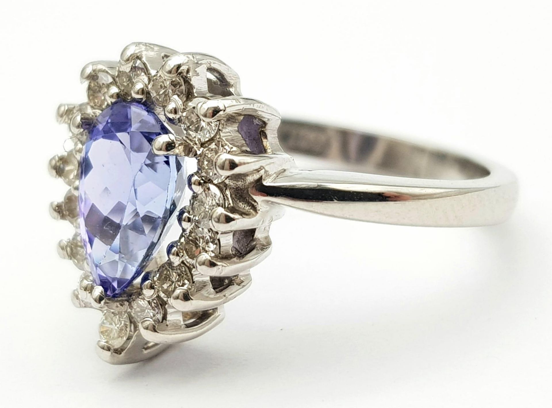 An 18 K white gold ring with a pear cut tanzanite (1.71 carats) surrounded by a halo of diamonds, - Image 4 of 12