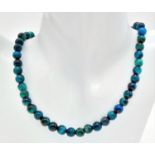 A blue (colour enhanced) tiger's eye necklace bringing luck and prosperity to the owner! Length: