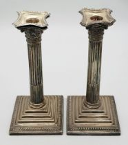 A PAIR OF SILVER CANDLESTICKS IN THE CORINTHIAN COLUMN STYLE , WOULD CLEAN UP WELL! 1150gms TOTAL