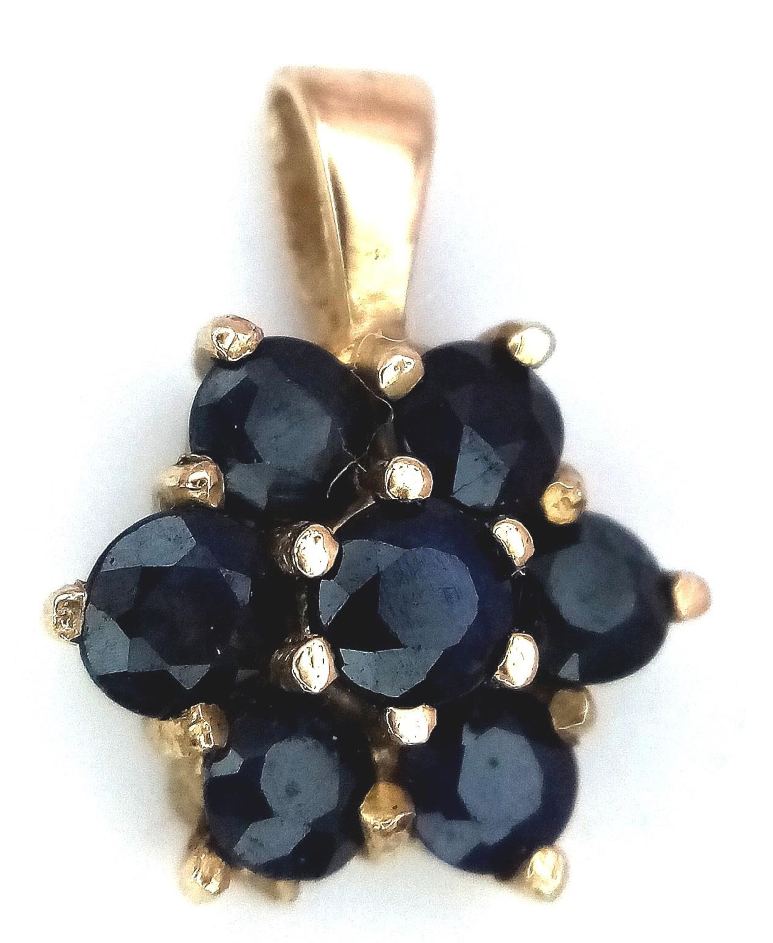 A 9K Yellow Gold Blue Stone (probably sapphire) Cluster Pendant. 1.4cm length, 1.1g total weight.