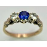 A 9K GOLD DIAMOND AND SAPPHIRE RING . 2.1gms size N