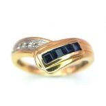 A Stylish 18K Yellow Gold Diamond and Sapphire Crossover Ring. Size L. 3.6g total weight.