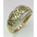 A 9K GOLD DIAMOND AND TOPAZ RING . 4.2gms size P