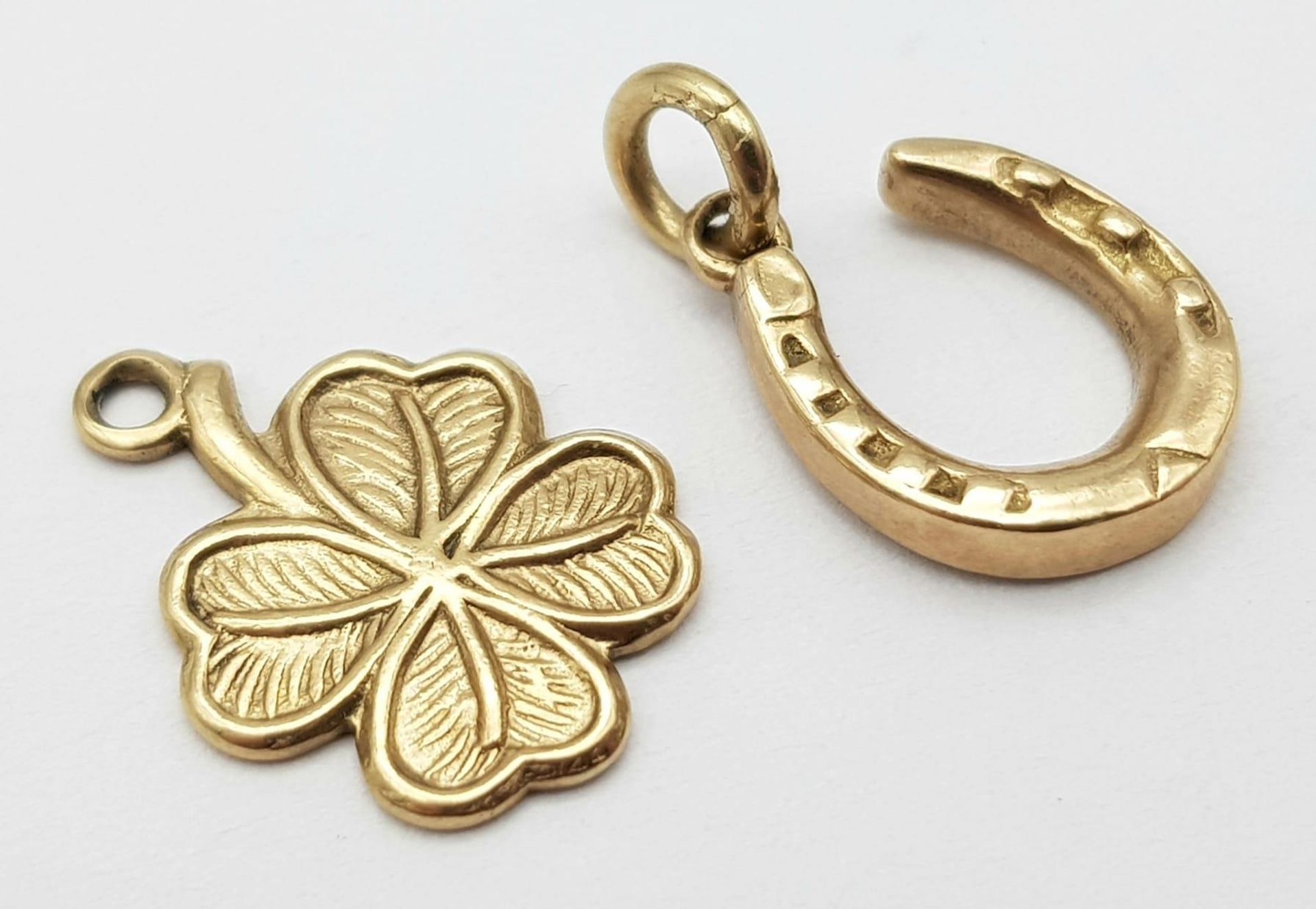Two 9K Yellow Gold Lucky Pendants/Charms - Horseshoe and clover. 2.32g total weight.