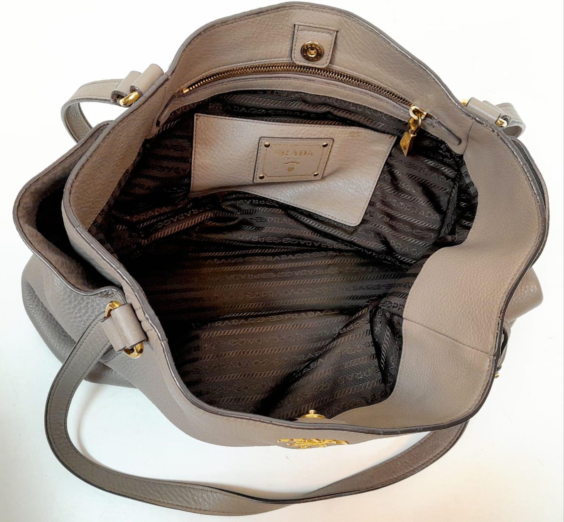 A Prada Grey Leather Shoulder Bag. Textured leather exterior with gold tone hardware. Textile and - Image 4 of 9