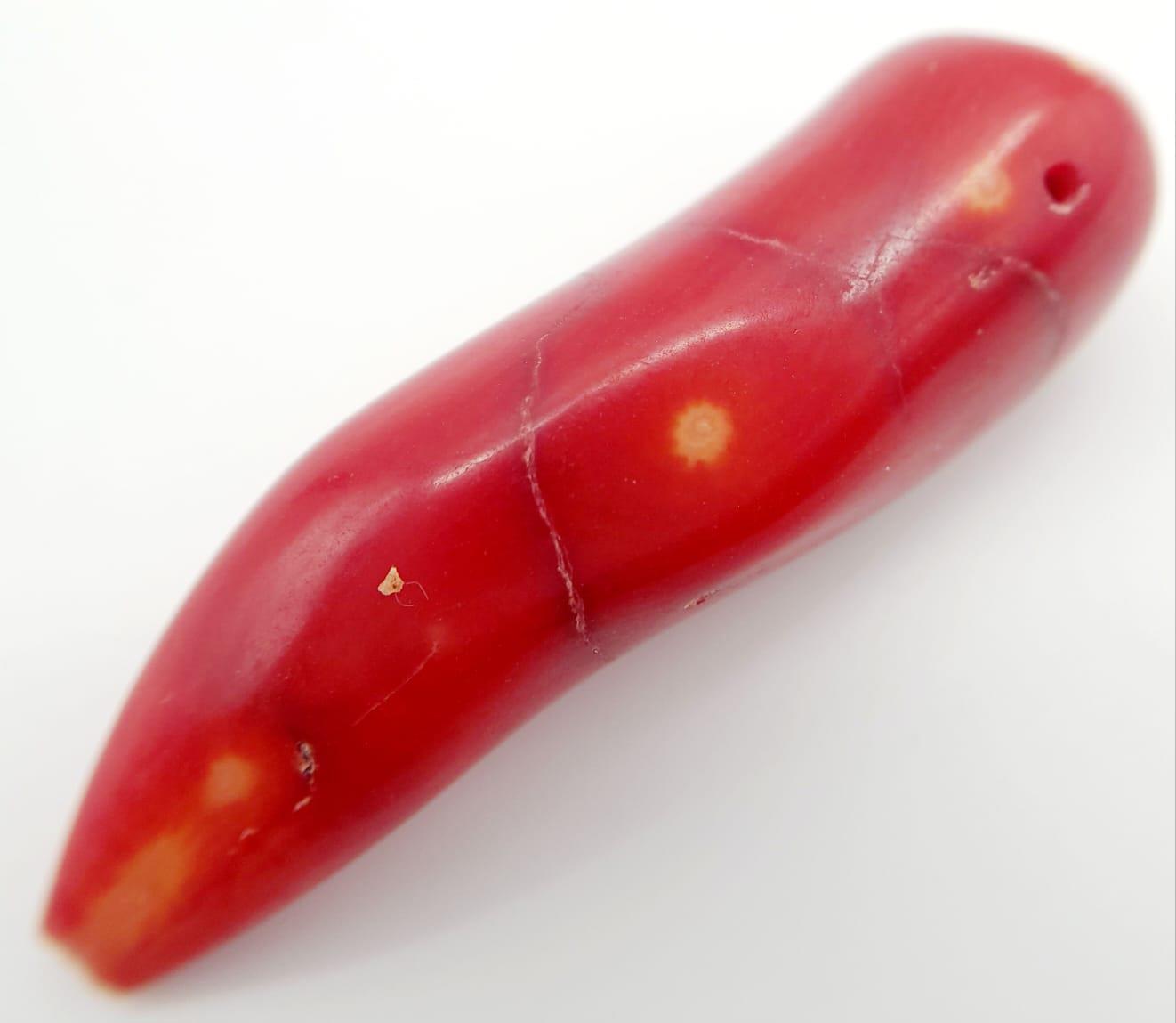 A 69.20ct Natural Italian Bamboo Red Coral, in the Oval Cabochon shape. Comes with the GLI