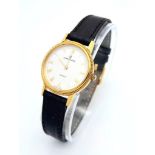 A Gold Plated Universal Quartz Ladies Watch. Black leather strap. Gold plated case - 23mm. White