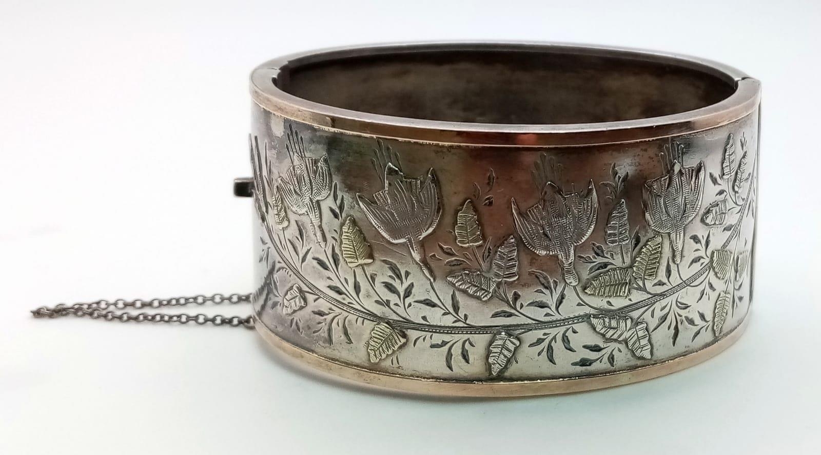 A vintage sterling silver click-on bangle with fabulous floral engravings. Come with full Birmingham