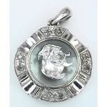 A VERY CUTE 18K WHITE GOLD DIAMOND SET PENDANT WITH SPINNING DOG IN THE CENTRE! 2.2G. 2CM.