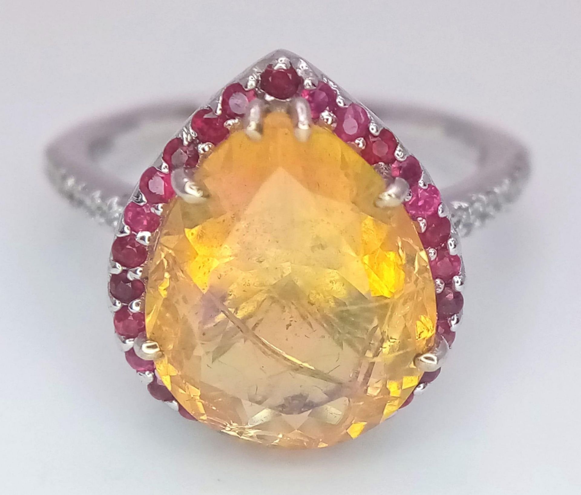 An 18 K white gold ring with a large, pear cut, fire opal exhibiting orange and green hues, - Image 6 of 9