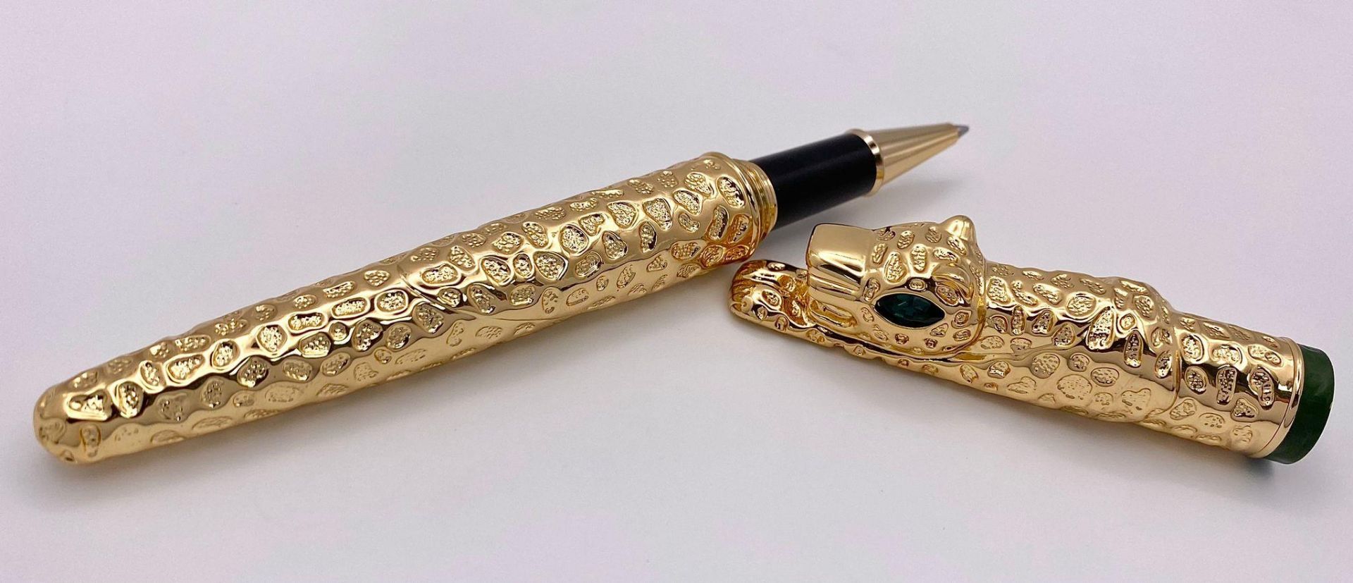 A very substantial, designer style, pen in the shape of a panther with emerald-green eyes, in a