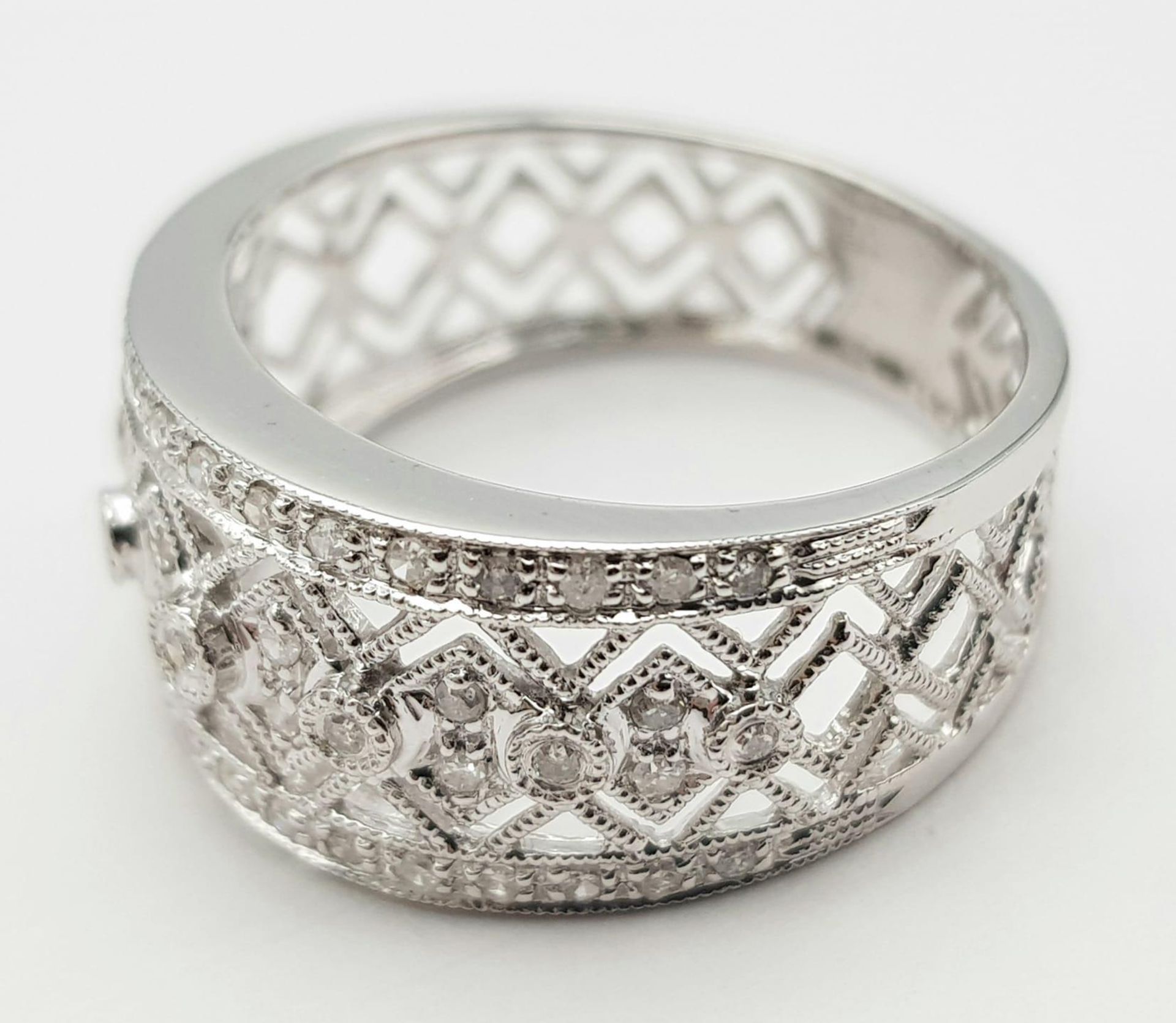 A 9K WHITE GOLD DIAMOND SET, WIDE OPEN-WORK DESIGN BAND RING. 3.3G. SIZE P. - Image 3 of 5
