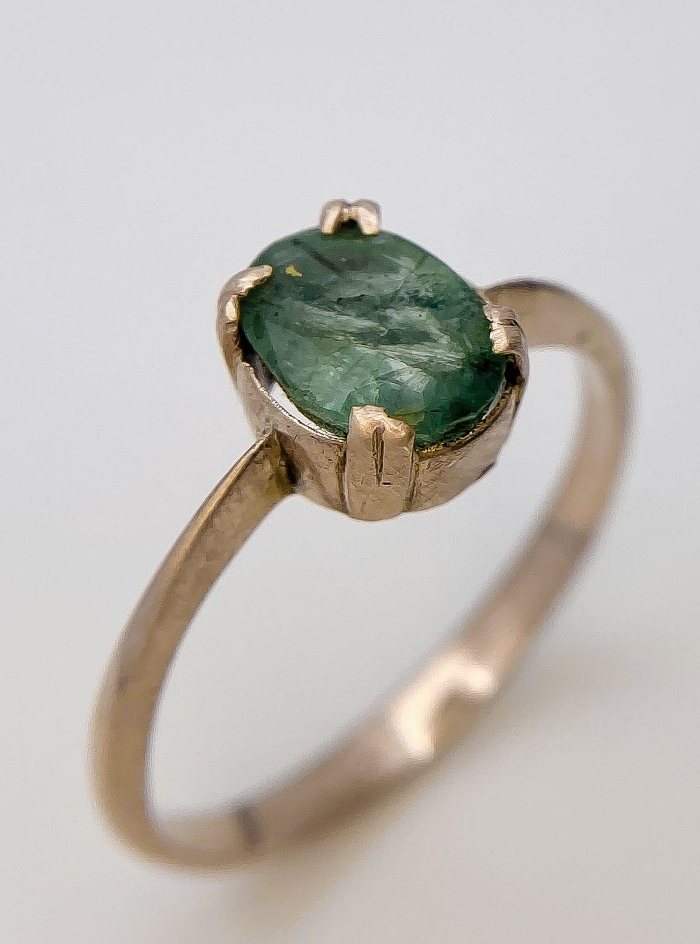 An 18K Yellow Gold Emerald Solitaire Ring. Size O. 2.12g