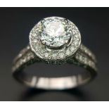 An 18 K white gold ring with a brilliant cut diamond (1.01 carats) surrounded by diamonds on the top