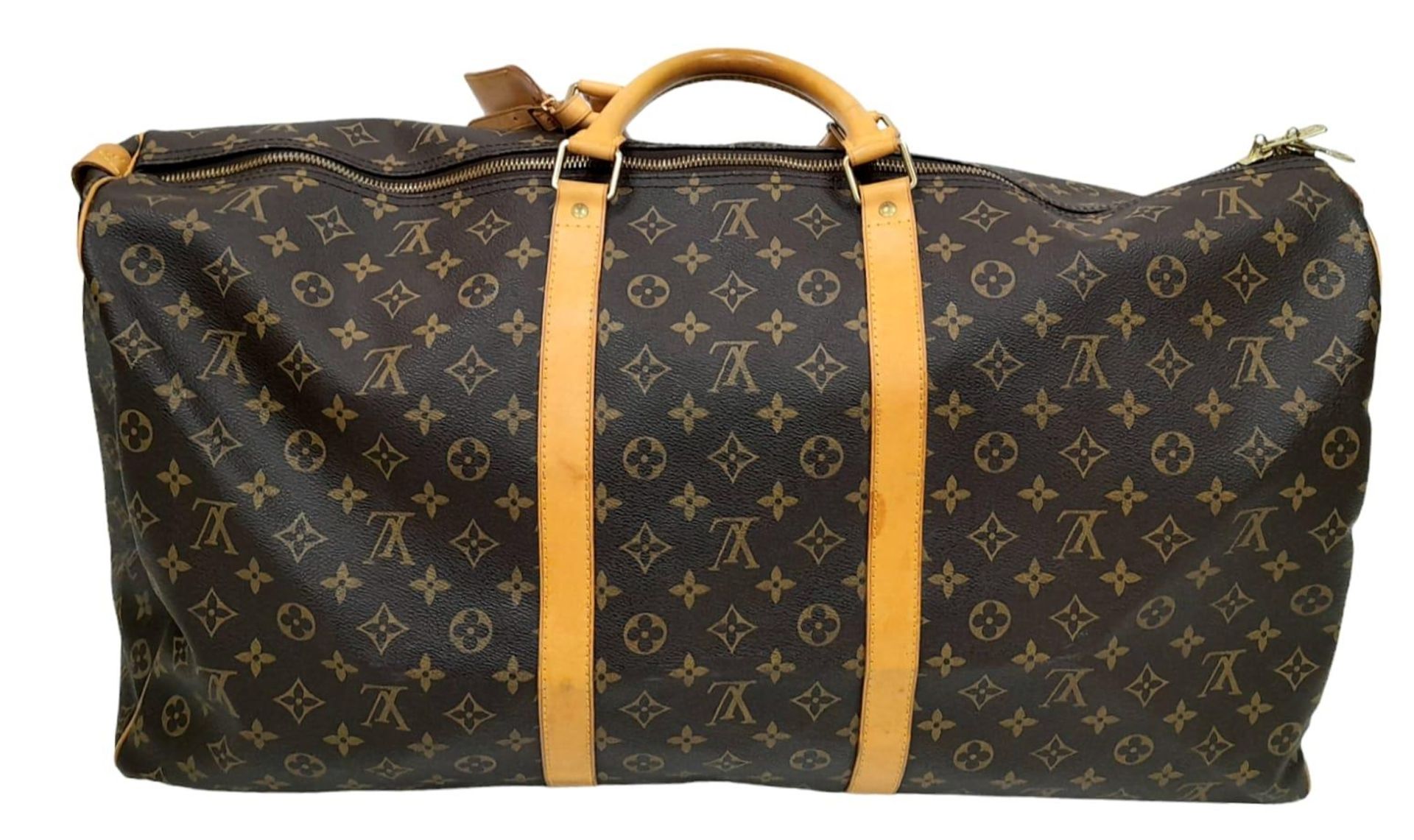 A Louis Vuitton Monogram Keepall 60 Travel Bag. Leather exterior with gold-toned hardware, two - Image 4 of 12