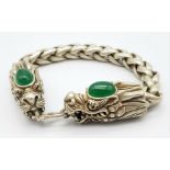 A Tibetan Silver and Green Jade Double Dragon Bracelet. Chinese dragon heads with jade cabochon