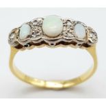 An Antique Opal and Diamond 18K Yellow Gold Ring. Three opals with diamond accents. Size O. 2.72g