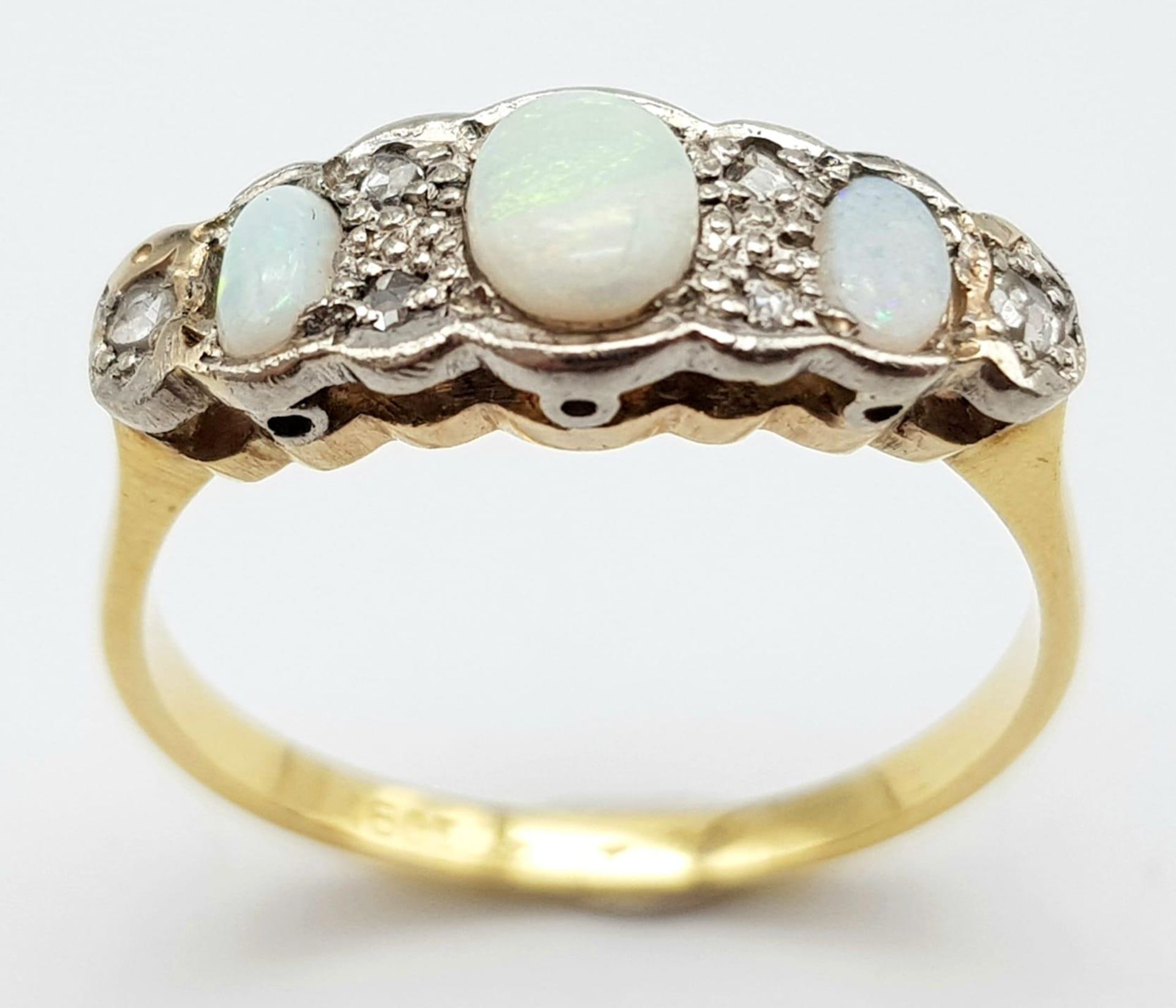 An Antique Opal and Diamond 18K Yellow Gold Ring. Three opals with diamond accents. Size O. 2.72g