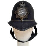 A British Metropolitan Police Helmet. Complete with original badge.
