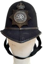 A British Metropolitan Police Helmet. Complete with original badge.