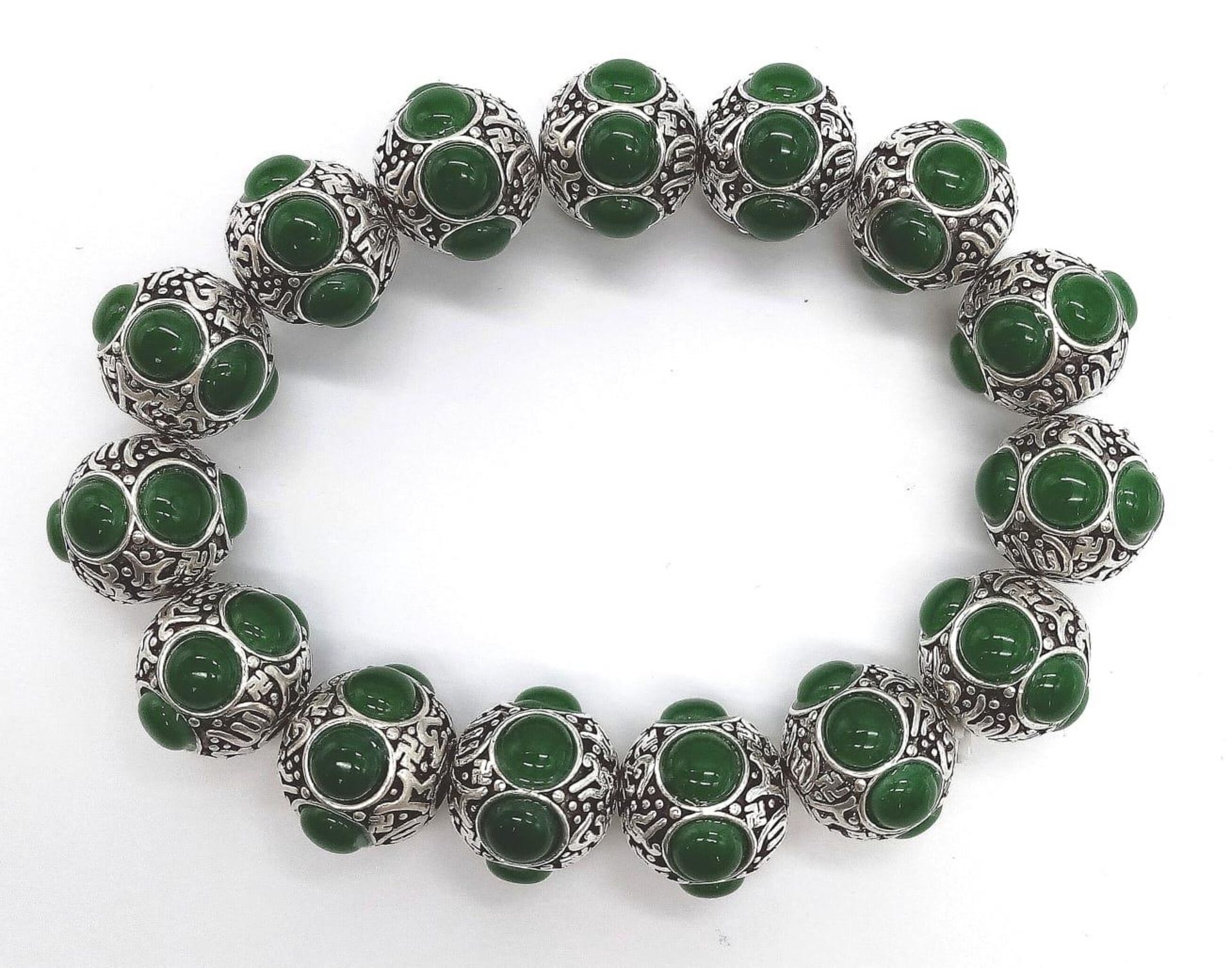 A Tibetan Silver and Green Jade Expandable Bracelet. Decorative jade cabochons and ancient Tibetan - Image 6 of 7