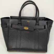 A Mulberry Bayswater Leather Handbag. Textured black leather exterior with gold tone hardware.