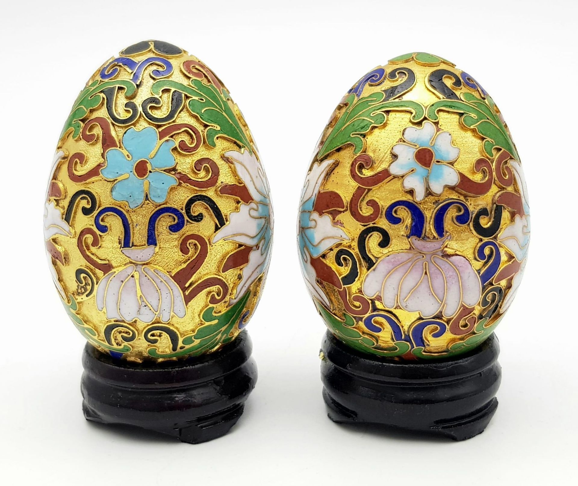Two vintage and very ornamental Chinese cloisonne eggs standing on custom-made wooden bases. Height:
