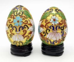 Two vintage and very ornamental Chinese cloisonne eggs standing on custom-made wooden bases. Height: