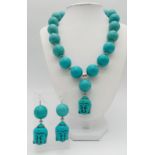 Of Buddhist interest: A large beaded (20 mm diameter) turquoise coloured necklace and earrings set