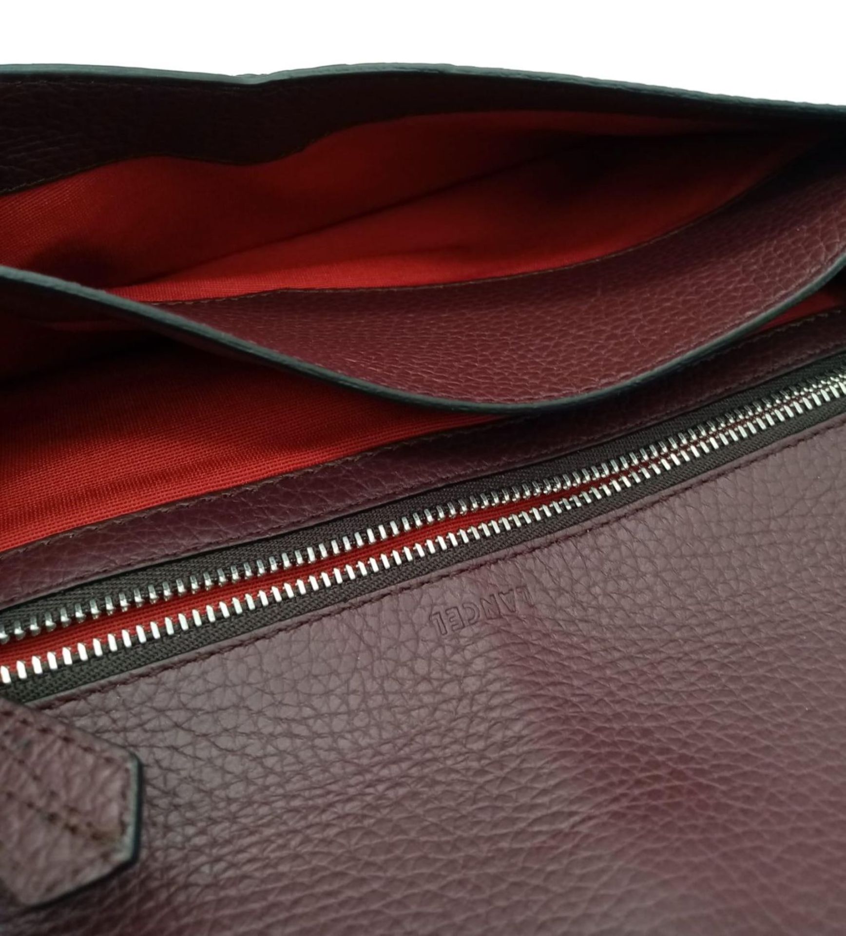 A Lance Burgundy Leather Hand/Shoulder Flap Bag. Textured leather exterior. Soft red textile - Image 11 of 16