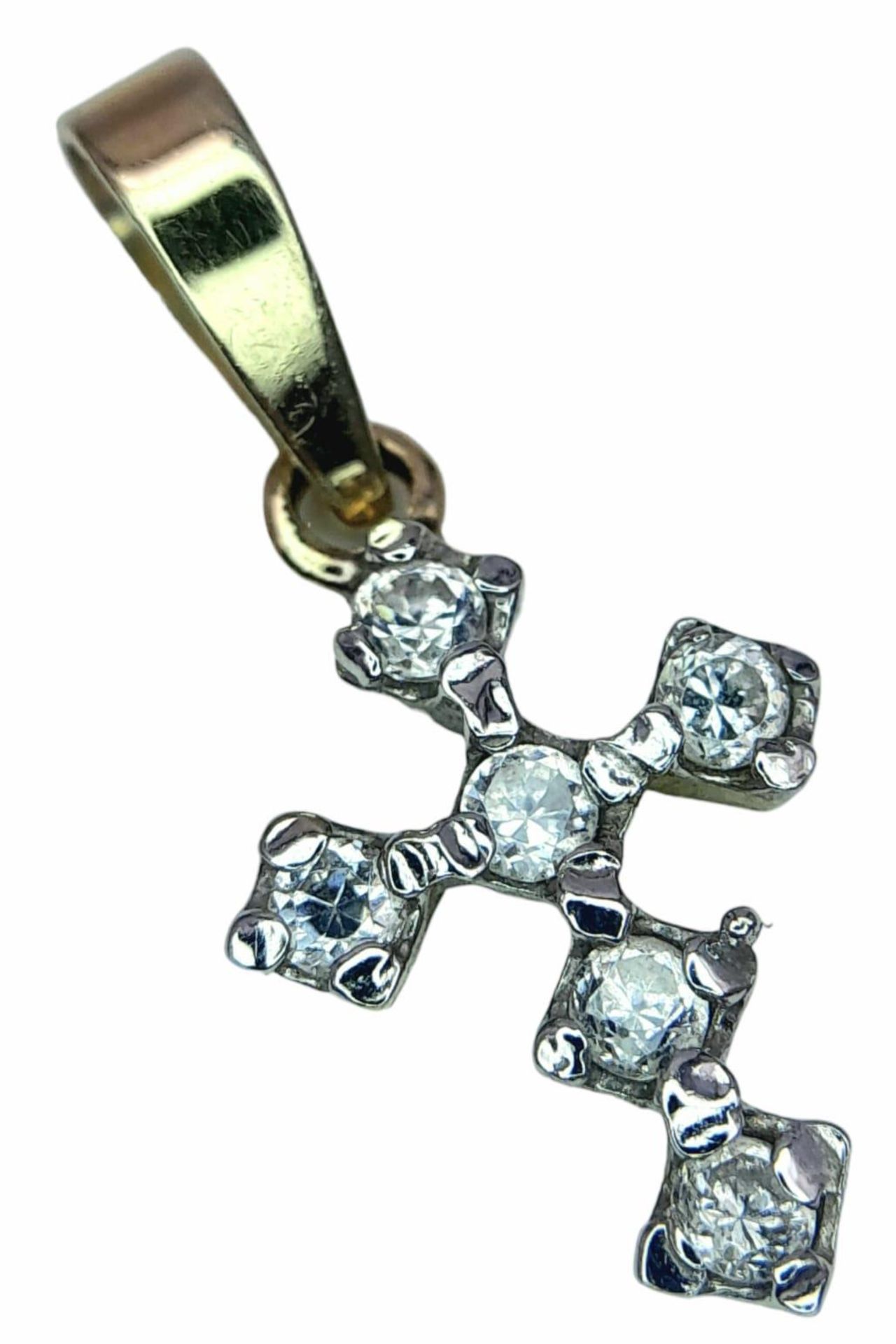 A fancy 14K yellow gold Zirconia cluster cross pendant. Total weight 1G.