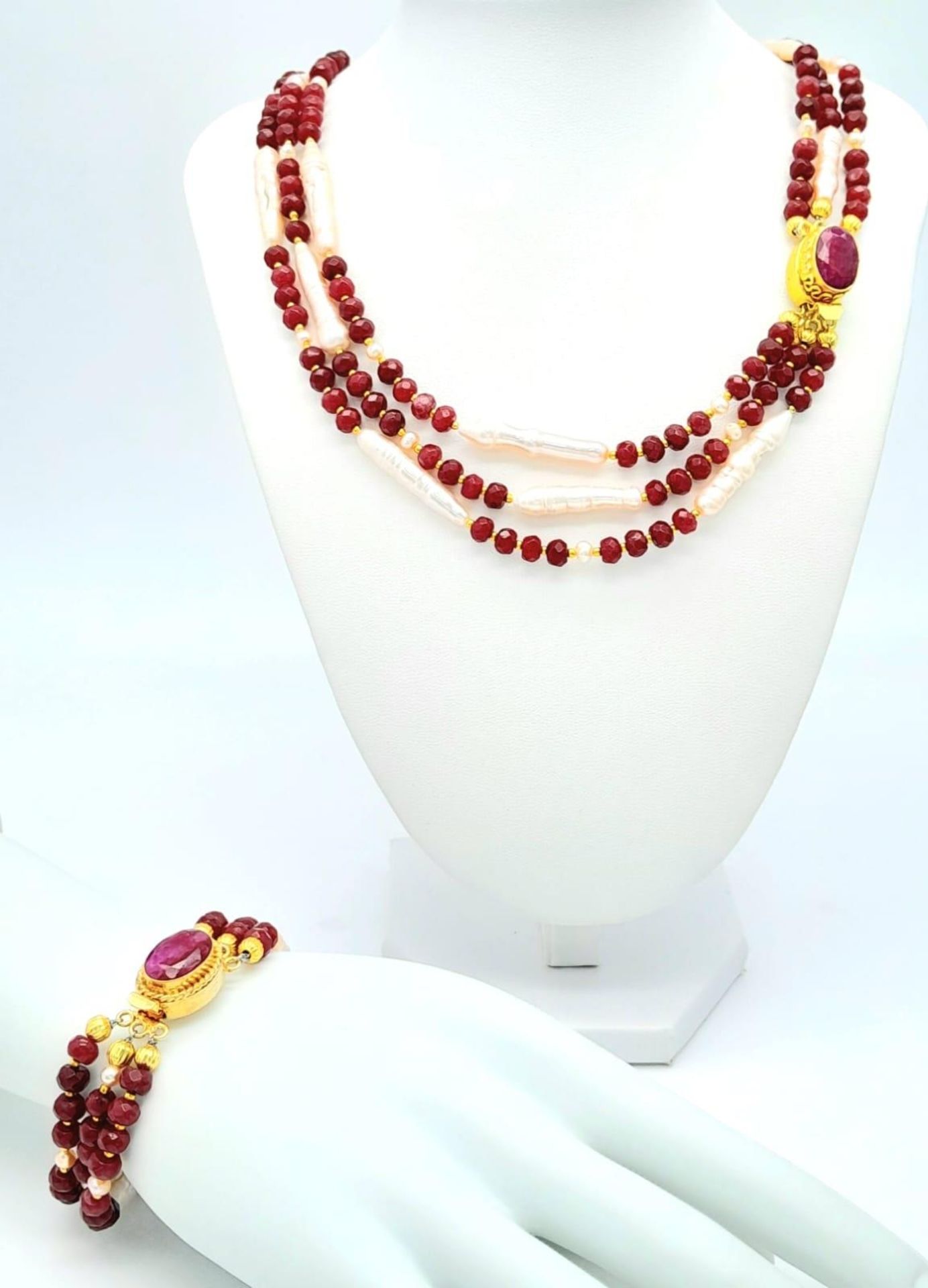 A very glamorous three row necklace and bracelet set with multi-faceted rubies and large, pink,