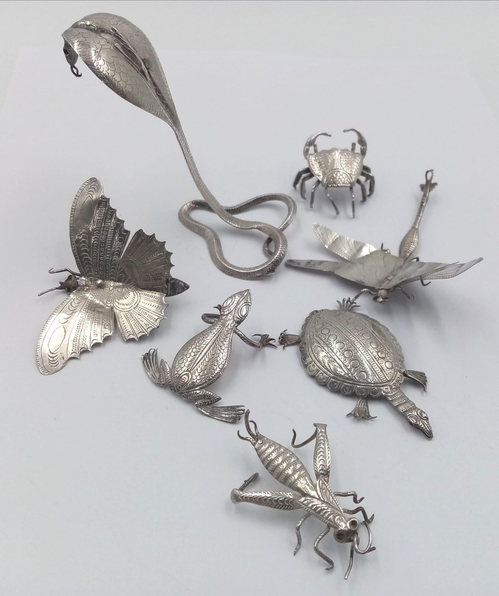 An interesting collection of hand crafted white metal animals and insects such as crab, snake,