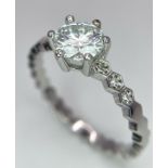 A sterling silver solitaire ring with a round cut moissanite 9! carat), size: P1/2, weight: 2.2 g.