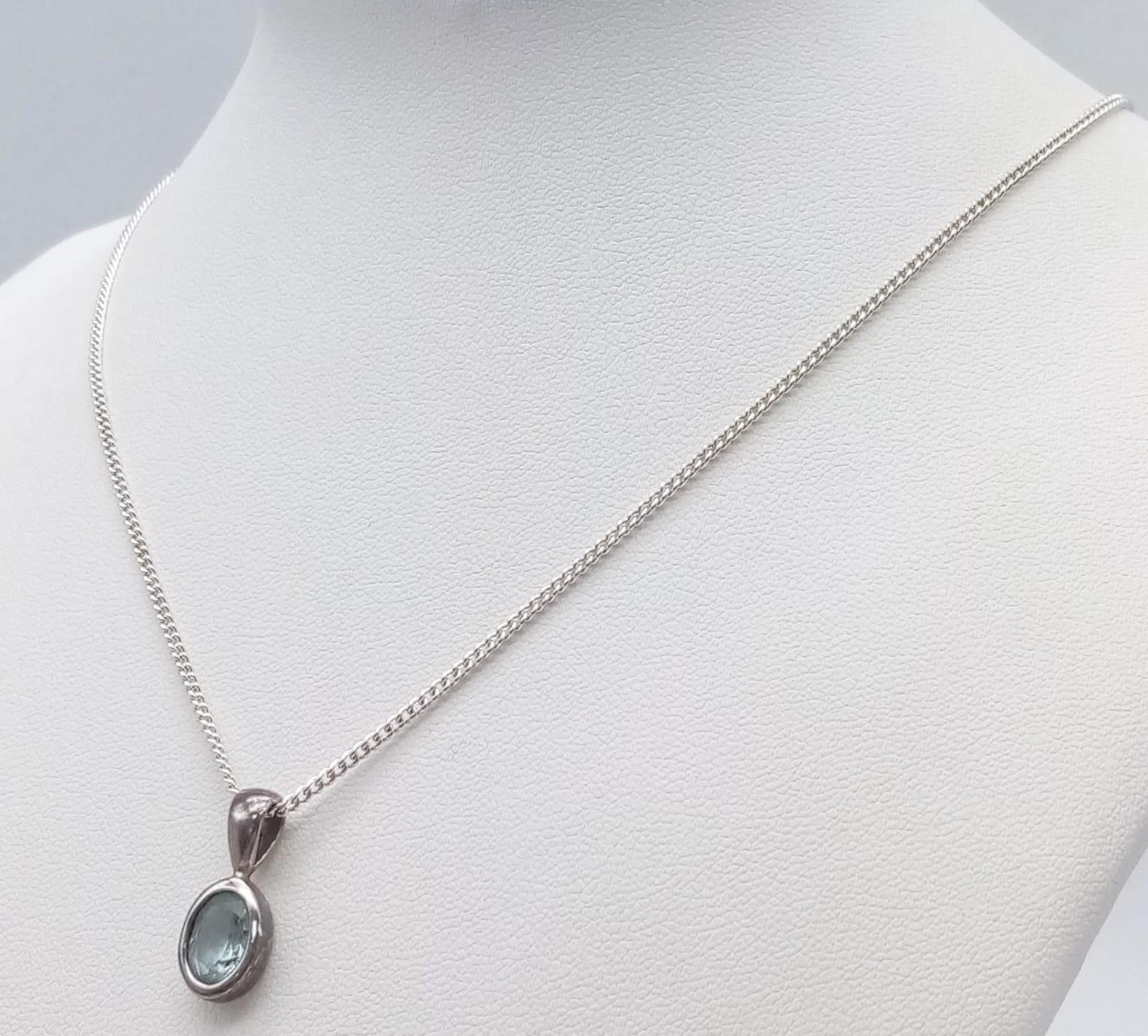 A Sterling Silver Blue Topaz Pendant on Chain. 1.8cm pendant, 46cm chain, 4.7g total weight. Ref: SC - Image 4 of 11