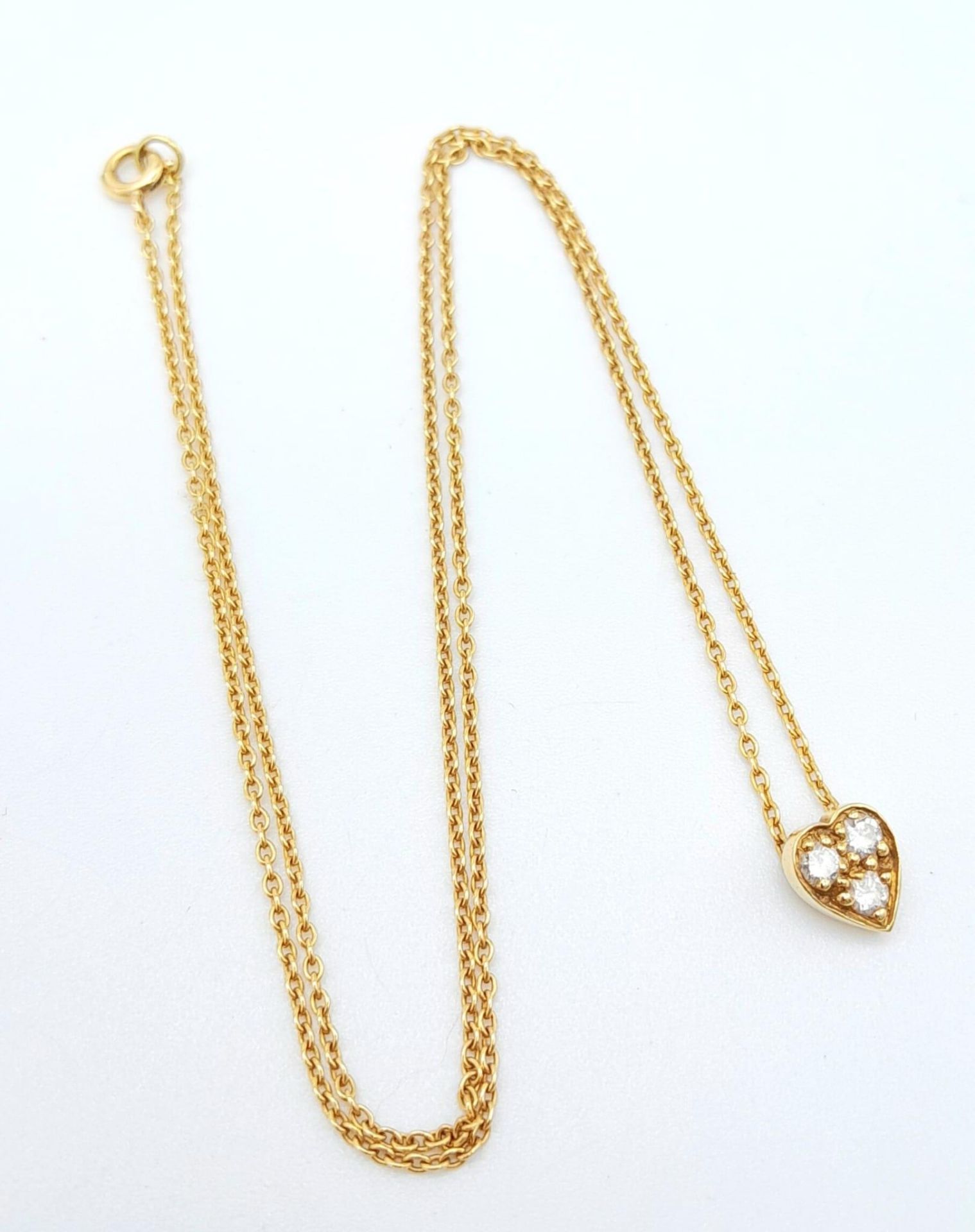 An 18K Diamond Heart Pendant on an 18K Yellow Gold Disappearing Necklace. Pendant - 6mm. 40cm