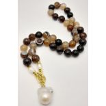 A Striped Agate Beaded Necklace with a Baroque Pearl Hanging Pendant. Gilded clasp. White stone