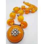 A Berber Amber Resin Statement Necklace and Pendant. 56cm length.