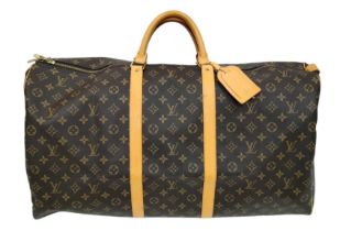 A Louis Vuitton Monogram Keepall 60 Travel Bag. Leather exterior with gold-toned hardware, two