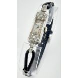 An Art Deco Platinum and Diamond Ladies Mechanical Watch. Rectangular case - 14mm. In working
