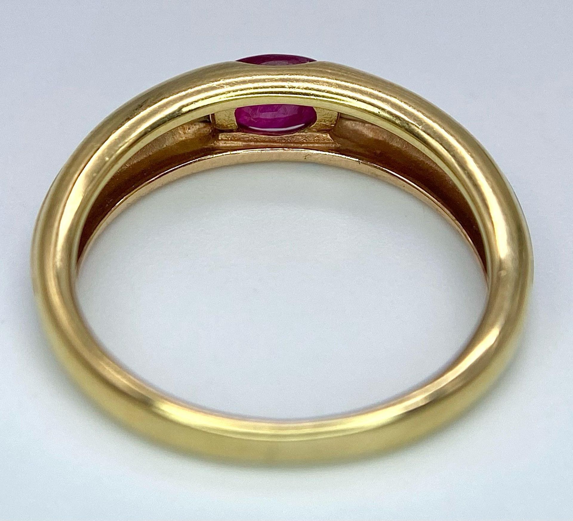 A 9K Yellow Gold Ruby Ring. Oval central ruby. Size N. 2.85g total weight. - Image 6 of 8